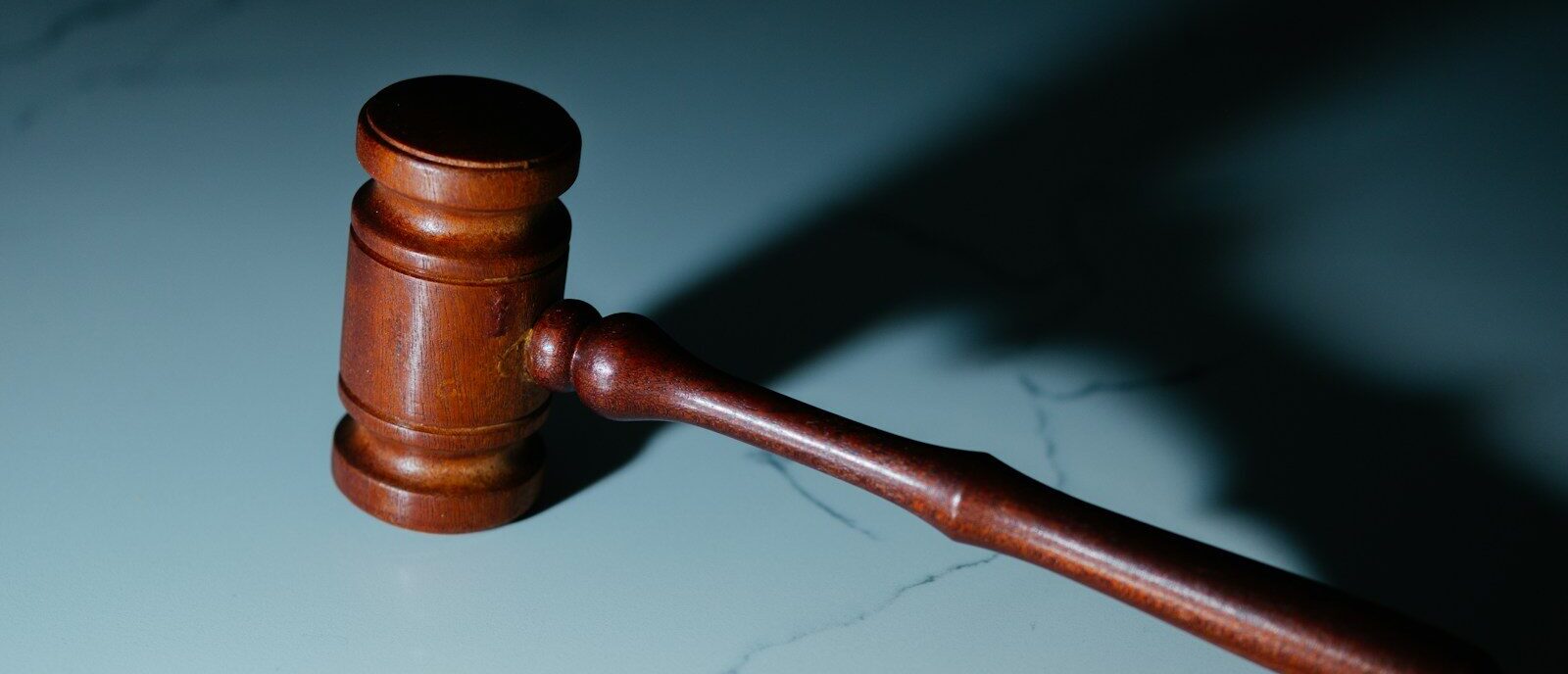 a wooden judge's hammer sitting on top of a table